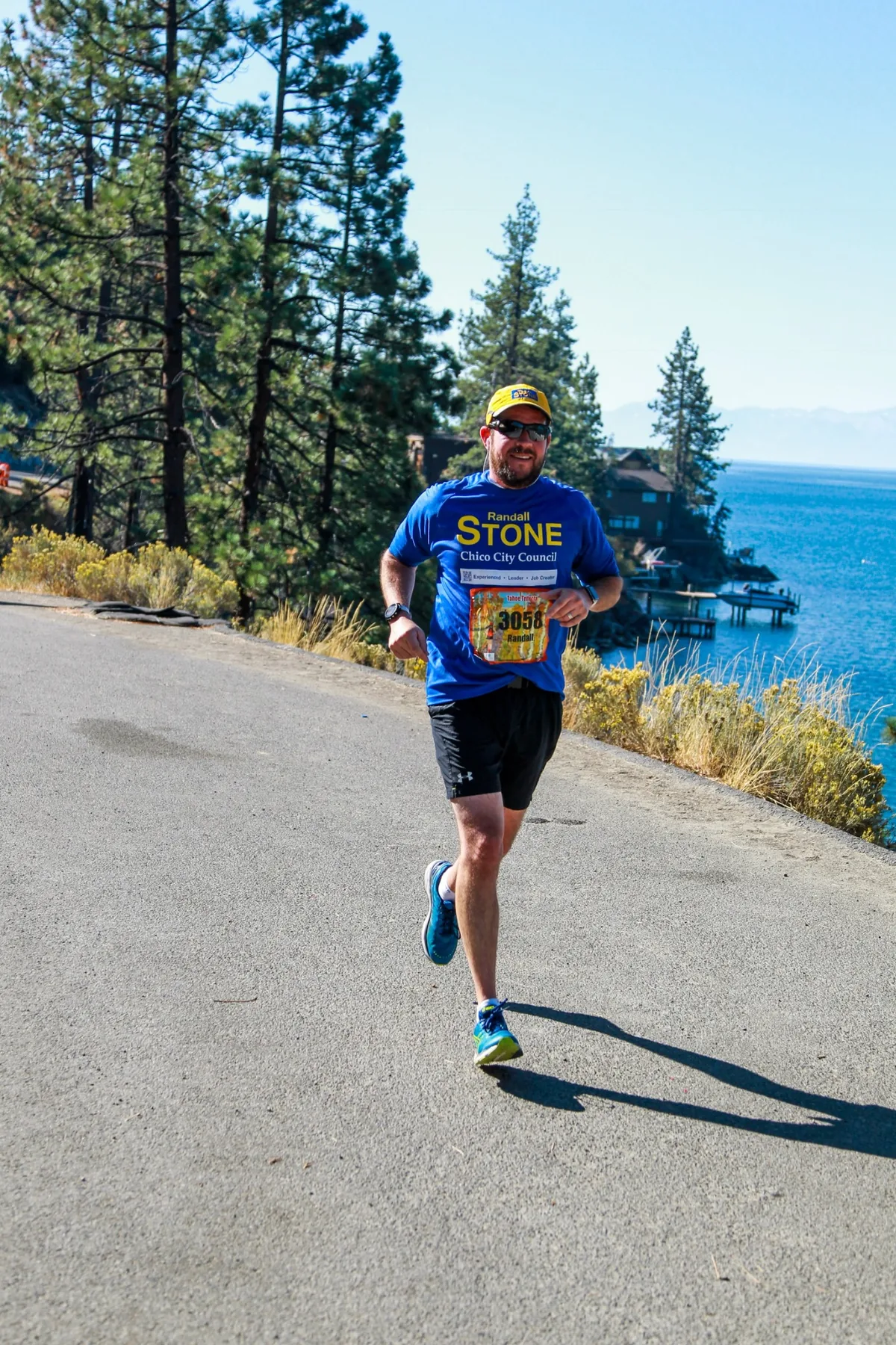 Randall Stone running beside Lake Tahoe during a Tahoe Triple event