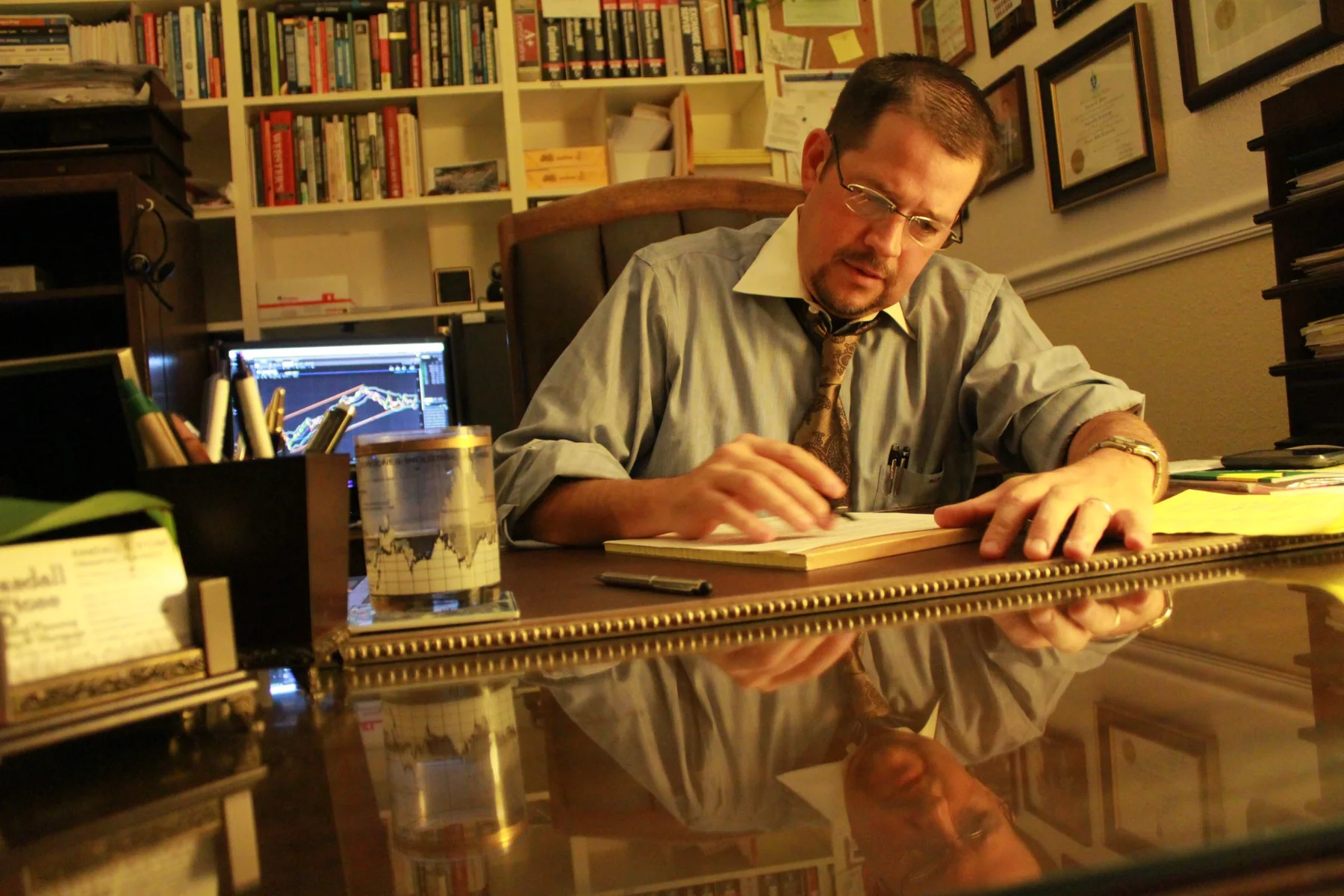 Randall Stone doing financial analysis at his desk